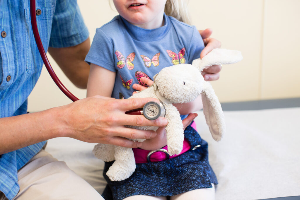 Child smiling at doctor during a checkup